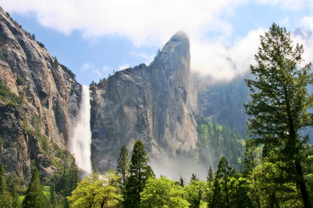 Bridalveil Fall pouring down a granite cliff in Yosemite Valley
